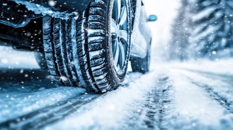 Car in the winter driving on snowy road